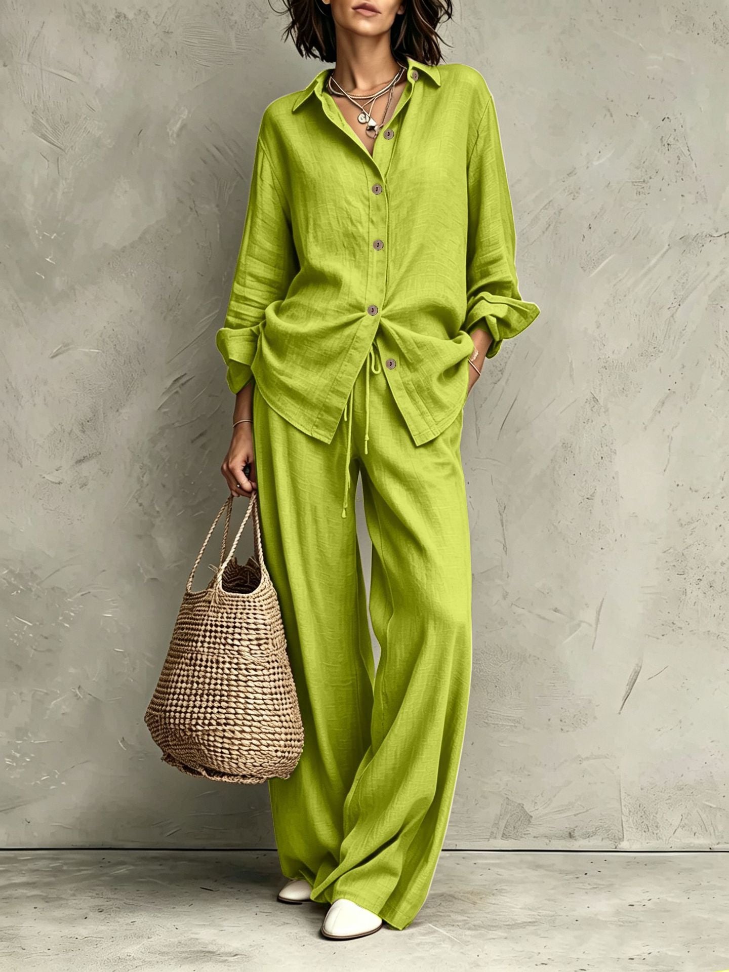 Women's button-down shirt and wide-leg pants set in black – full outfit front view showing relaxed casual silhouette and straw bag