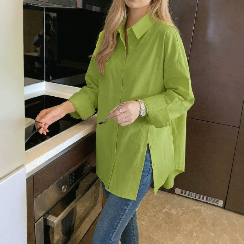 Close-up view of a women's oversized button-down shirt highlighting the collar, button placket, and fabric texture.