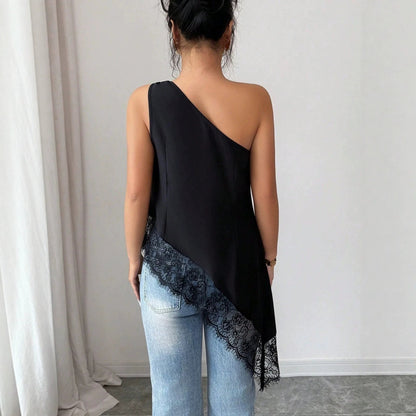 Back view of black off-shoulder lace patchwork vest with irregular hem paired with jeans