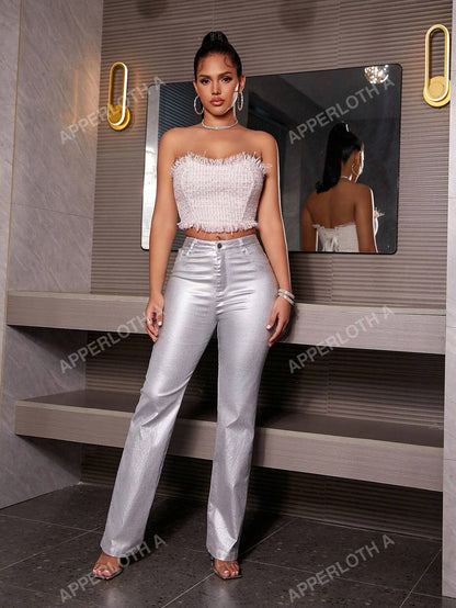 A model wearing Apperloth A silver metallic high-waisted PU leather straight-leg pants, paired with a white feather-textured strapless crop top and heels.