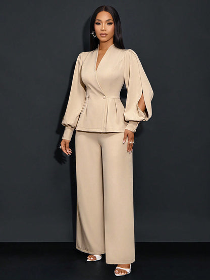 Front full-length view of a woman posing in an apricot beige suit set featuring a V-neck peplum blazer with long bishop slit sleeves, paired with matching wide-leg trousers.