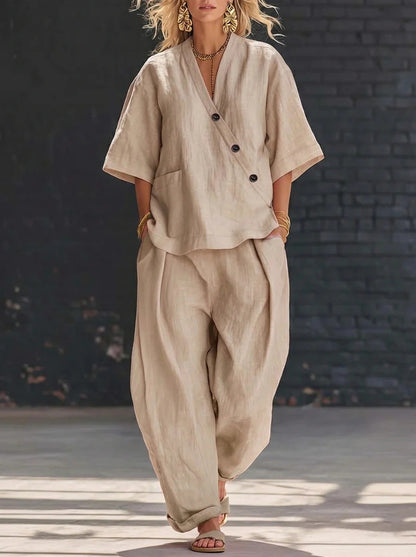 Model wearing a beige button-accent V-neck short-sleeve top and matching high-waist trousers set.