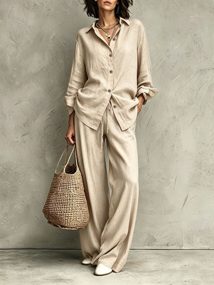 Women's button-down shirt and wide-leg pants set in apricot – full outfit front view showing relaxed casual silhouette and straw bag