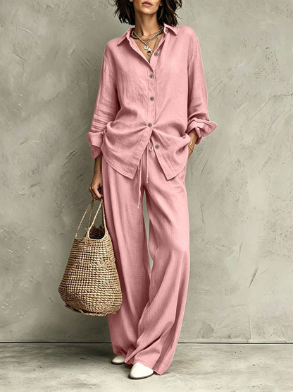 Women's button-down shirt and wide-leg pants set in pink – full outfit front view showing relaxed casual silhouette and straw bag