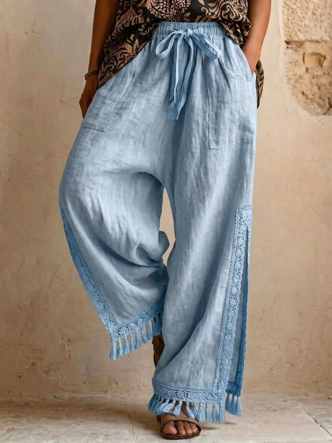 Women's bohemian lace tassel wide-leg pants in sky blue, featuring a drawstring waist, side slit with fringe trim, and a flowing silhouette.