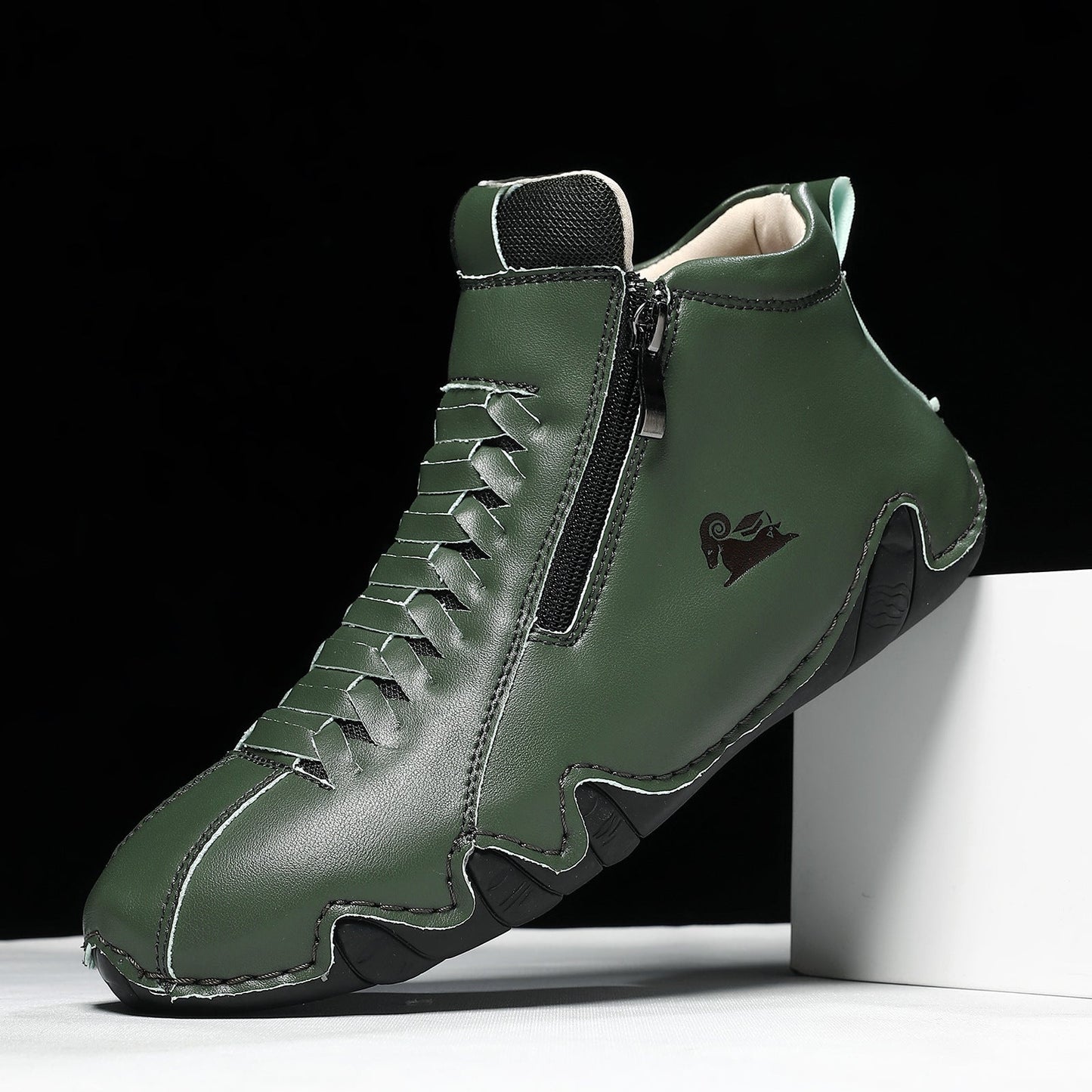 Dark green high-top athletic sneaker with a textured finish, side zipper, lace-up front, and cushioned sole, displayed against a black and white background.