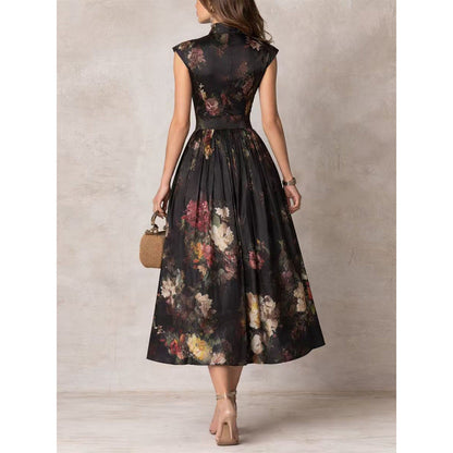 Back view of a woman wearing a black sleeveless maxi dress featuring a mandarin collar, cinched waist, and a voluminous A-line skirt with a vibrant 3D floral print.
