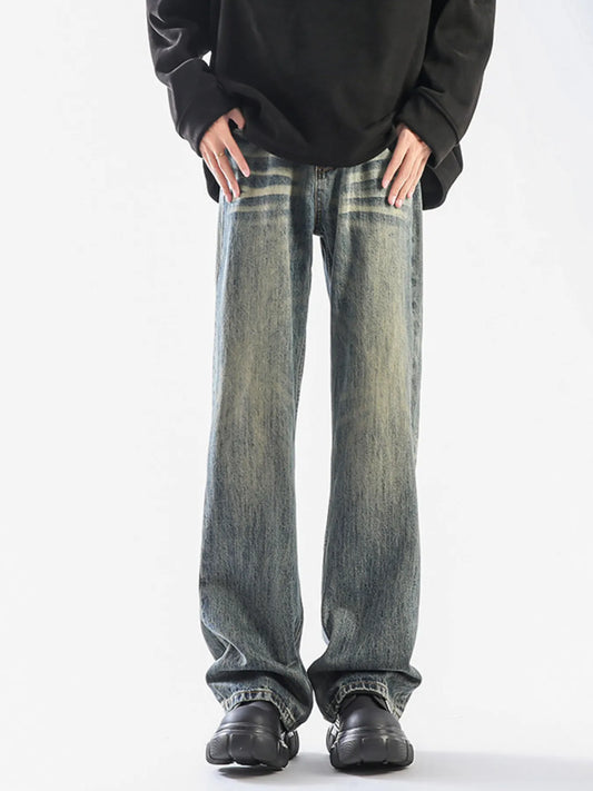 A man wearing vintage-wash wide-leg denim jeans and a dark top.