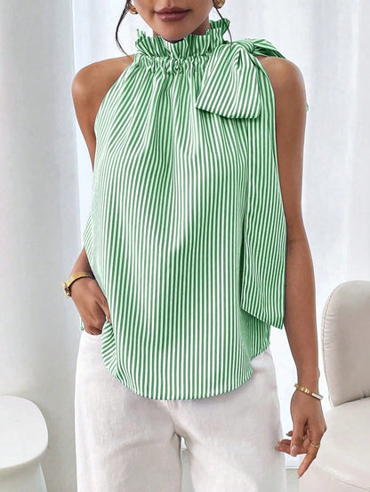 Model wearing a light green and white striped sleeveless top featuring a ruffled high neck and side tie-knot bow detail.