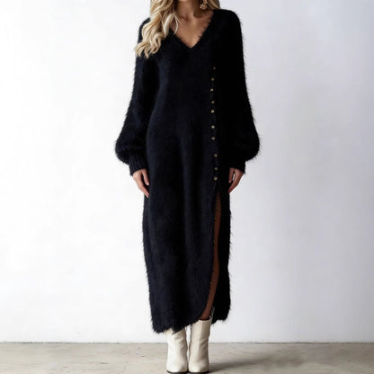 Woman wearing a black fuzzy knit long-sleeve midi dress with button details and a high side slit