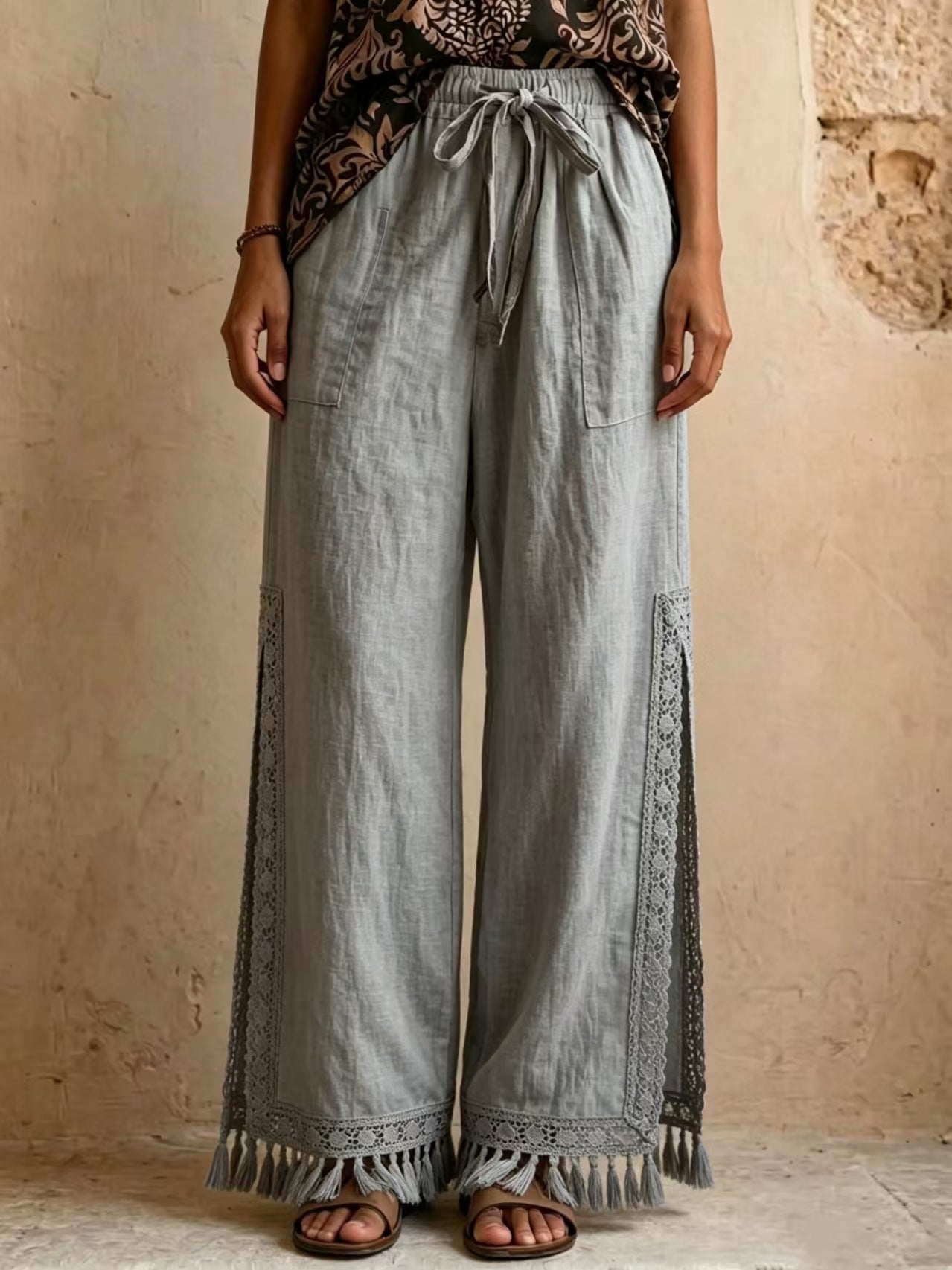 Women's bohemian lace tassel wide-leg pants in gray, featuring a drawstring waist, side slit with fringe trim, and a flowing silhouette.