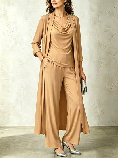 Camel tan three-piece women's set featuring a long open duster cardigan, sleeveless cowl neck top, and fluid wide-leg pants.