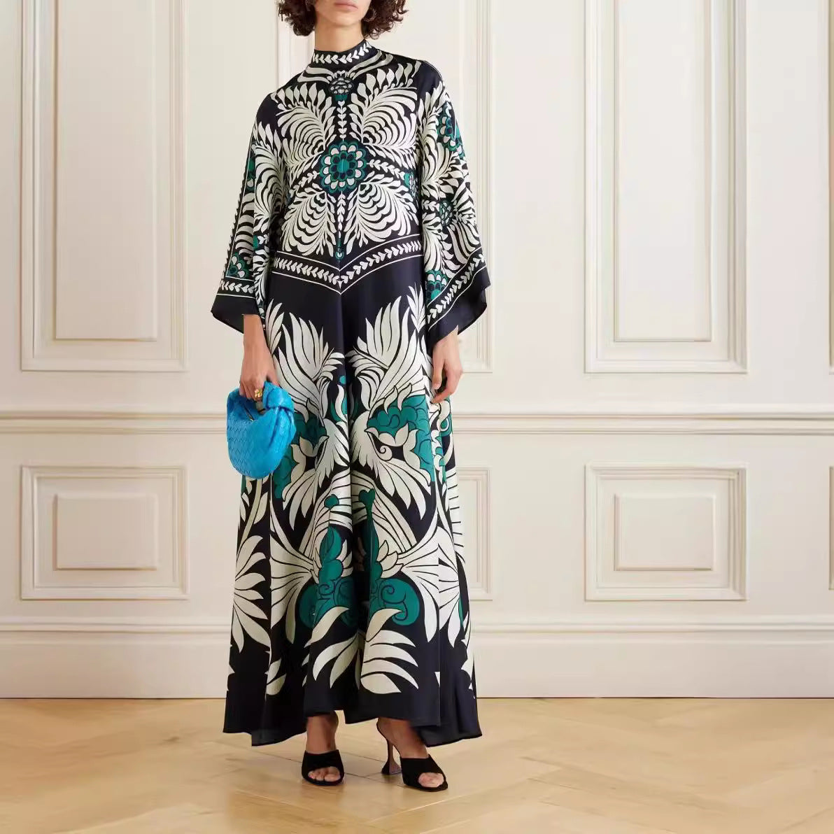 Tibetan blue maxi dress featuring a bold botanical paisley print, stand-up collar, flared 3/4 sleeves, and a floor-length A-line silhouette.