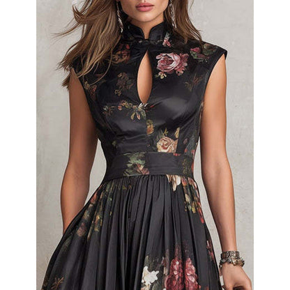Close-up view of a woman wearing a black sleeveless maxi dress featuring a structured mandarin collar, keyhole neckline cutout, and fitted bodice with a vibrant 3D floral print.