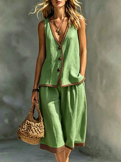 Women's light green sleeveless buttoned vest and matching cropped wide-leg pants two-piece set featuring contrast trim detailing, modeled outdoors with a woven handbag.