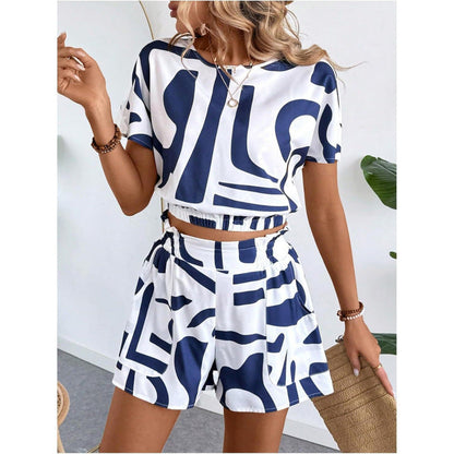 Woman wearing a printed casual two piece set featuring a blue and white geometric short sleeve top and matching high-waisted shorts.