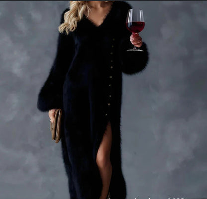 Woman wearing a black fuzzy knit long-sleeve midi dress with button details, side slit, holding a wine glass