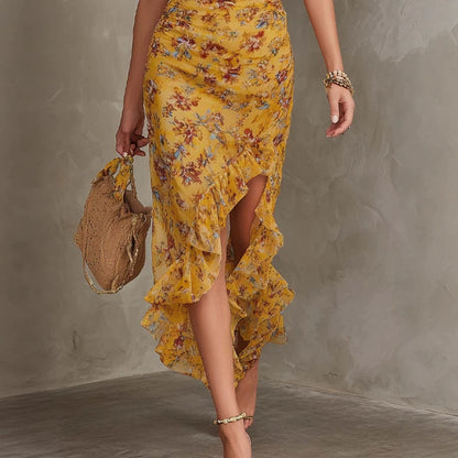 Close-up view of ruffle split hem, waist-cinching detail, and woven bag styling on Women's Halter Neck Deep V Floral Maxi Dress