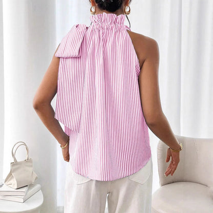 Back view of a model wearing a pink and white striped sleeveless top featuring a ruffled high neck and side tie-knot bow detail.