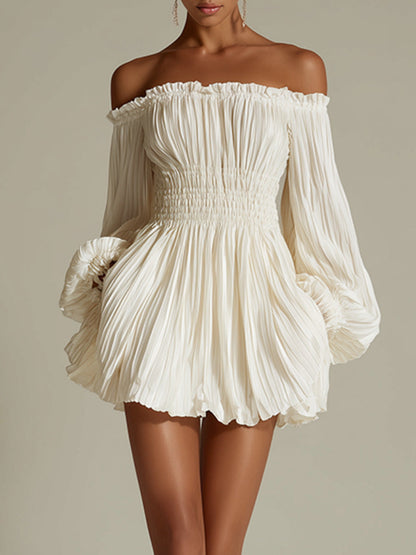 Close-up of fabric texture on a cream white pleated mini dress