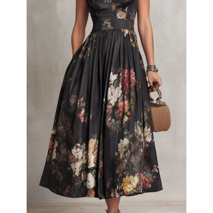 Close-up view of a woman wearing a black sleeveless maxi dress featuring a structured mandarin collar, keyhole neckline cutout, and fitted bodice with a vibrant 3D floral print.