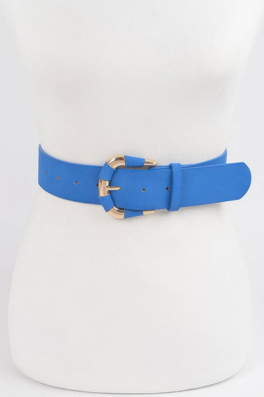Front view of a cobalt blue micro suede belt with a gold-tone buckle, styled around a white dress mannequin against a light background.