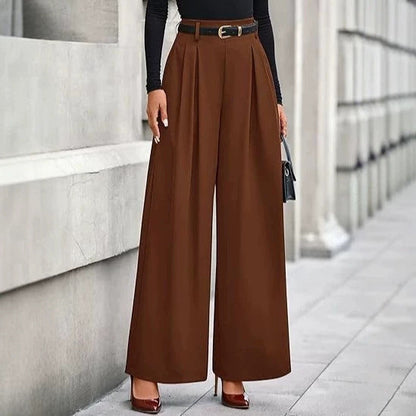 Women's pleated wide-leg trousers in rich brown featuring a slimming drape silhouette, structured front pleats, and a belted adjustable waist