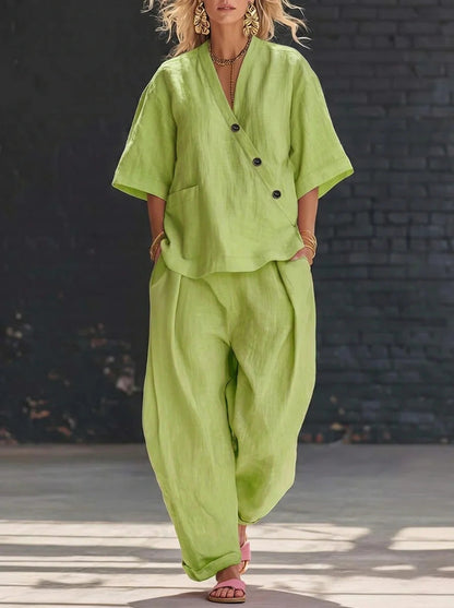 Model wearing a yellow-green V-neck short-sleeve top and matching high-waist trousers set.