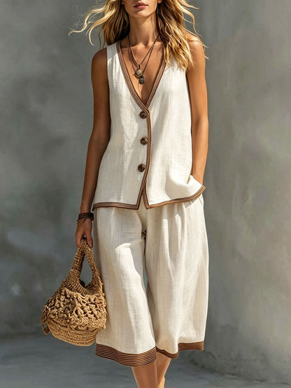Women's beige sleeveless buttoned vest and matching cropped wide-leg pants two-piece set featuring contrast trim detailing, modeled outdoors with a woven handbag.