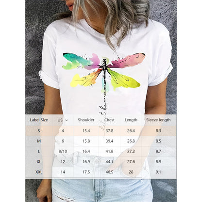 "A woman wearing a white short-sleeve casual t-shirt with a colorful watercolor dragonfly print and script lettering, overlaid with a product size chart table."