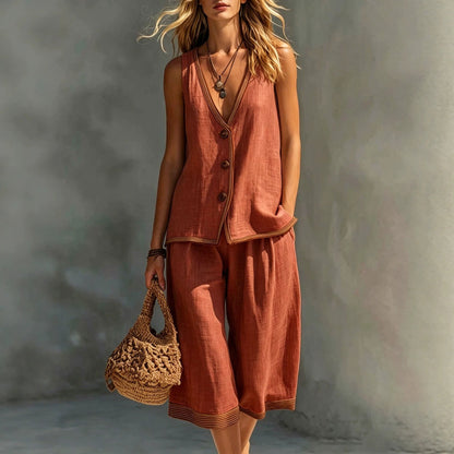 Women's wine red sleeveless buttoned vest and matching cropped wide-leg pants two-piece set featuring contrast trim detailing, modeled outdoors with a woven handbag.